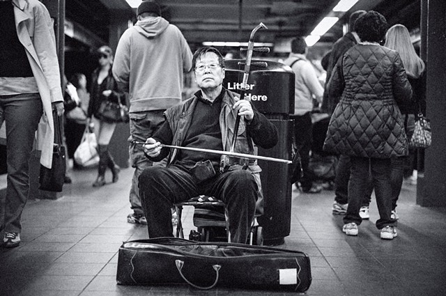 Photograph of an Ehru Player, 34th Street Subway, Manhattan, New York, by Judith Ebenstein