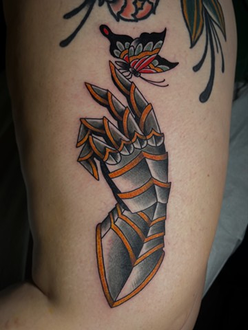 Explore a traditional gauntlet with butterfly tattoo design from Animal Farm Tattoo in Chicago. Bold American traditional flash with classic imagery — walk-ins welcome or book custom work.