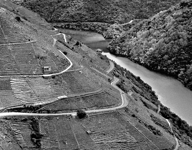 "Ribera Sacra with a View of River Sil-1"

A wine-growing region nestled in the gorge formed by the river Sil in Galicia. What look like horizontal lines on the hill at left are terraces where the vines are grown. See also"Ribeira Sacra Doade".