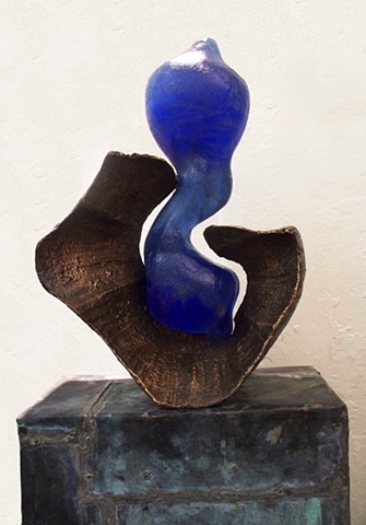 A cast glass and bronze sculpture that illustrates the beginning of life