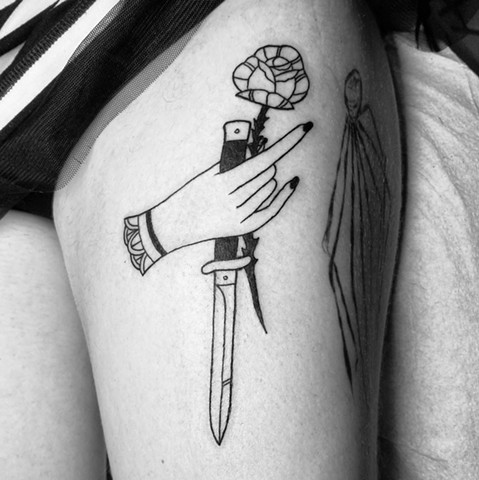Hand holding switchblade and rose