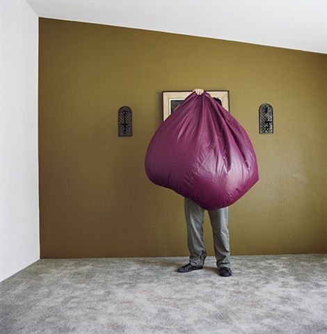 Man holding bean bag, manufactured display home, © Amy Eckert www.amyeckertphoto.com