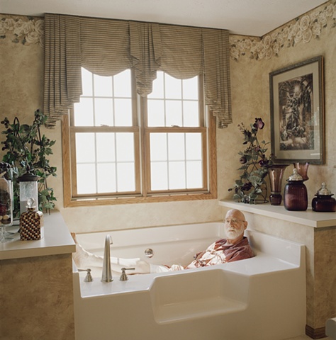 Man in bathtub, manufactured display home, © Amy Eckert www.amyeckertphoto.com