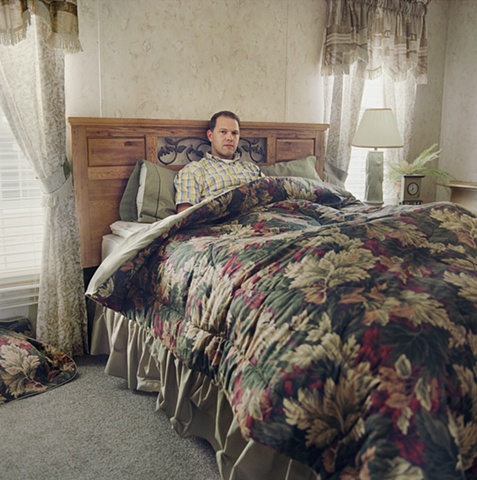 Man in bed, manufactured display home,  Amy Eckert www.amyeckertphoto.com