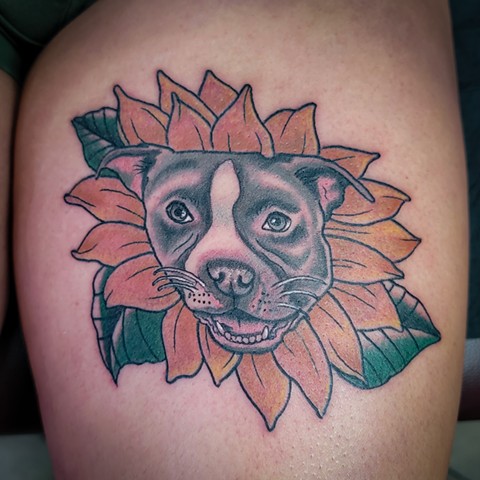 Dog portrait in sunflower tattoo on thigh by Gina Matuo of Copper Fox Tattoo in Kissimmee Florida best tattoo artist near me