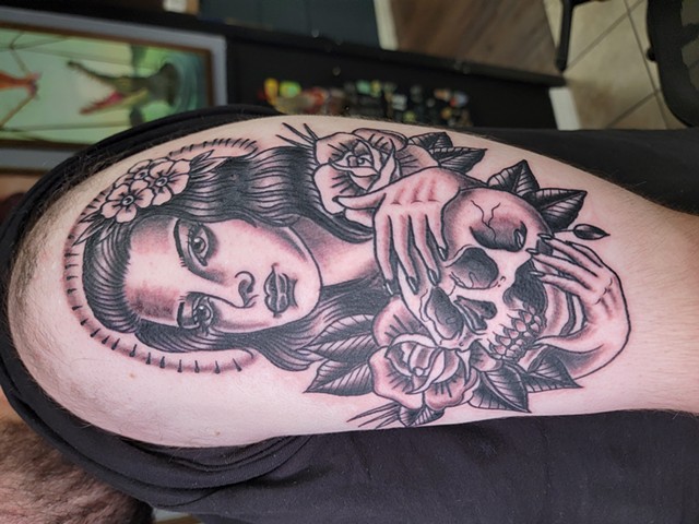 Lady head with skull traditional black and grey tattoo on upper arm by Gina Matsuo at Copper Fox Tattoo in Kissimmee Florida