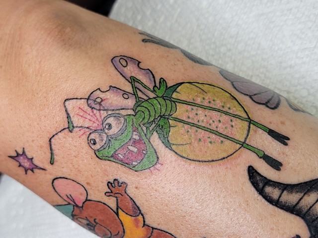 Raymond Firefly from Disney's Princess and the frog on forearm by Gina Matsuo at Copper Fox Tattoo in Kissimmee Florida best tattoo shop near me