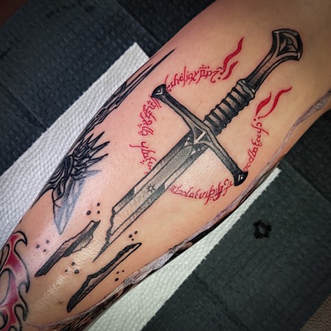 Sword of Narsil from Lord of the Rings on lower leg by Gina Matsuo of Copper Fox Tattoo in Kissimmee Florida best traditional tattoo shop near me LOTR tattoos