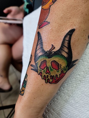 Poison Apple and Maleficent Mashup from Disney's Snow White on forearm by Gina Matsuo at Copper Fox Tattoo in Kissimmee Florida  best tattoo shop near me