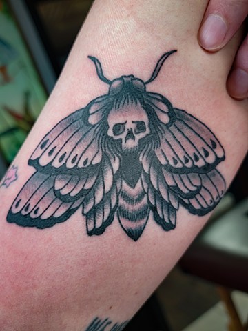 Black and grey traditional style deaths head moth on inner arm by Gina Matuo of Copper Fox tattoo in Kissimmee Florida best tattoo shop orlando tattoo artist