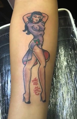 Traditional Style Pin Up from Sailor Jerry flash by Tahiti Gil of Copper Fox Tattoo in Kissimmee Florida best street tattoo shop near me