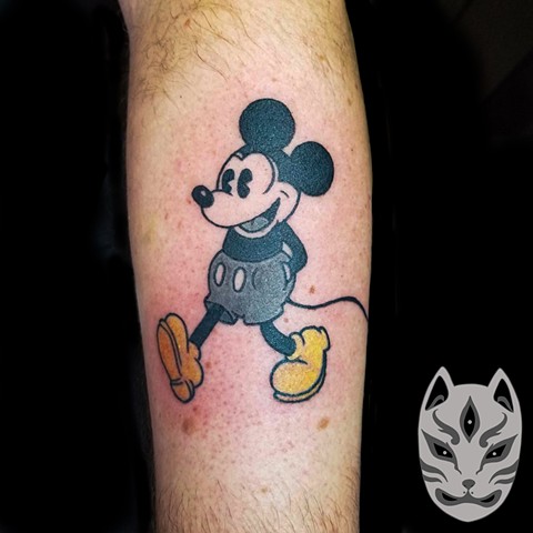 Classic pie eyed Mickey Mouse tattoo on forearm 