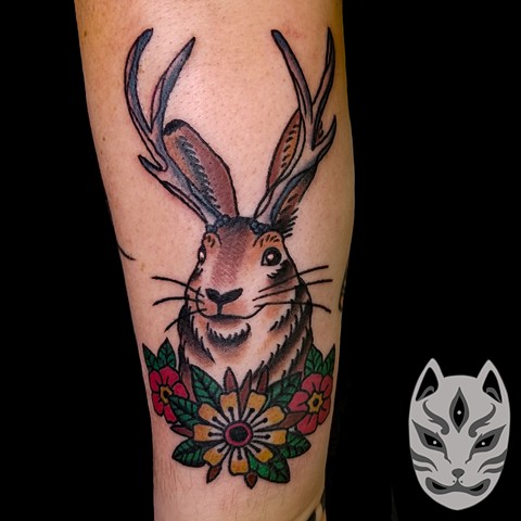 Traditional style Jackalope with traditional flowers on forearm by Gina Matuo of Copper Fox in Kissimmee Florida
