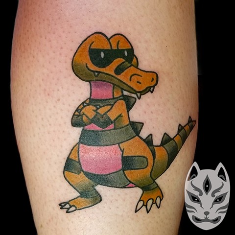 Krokorok from Pokemon is a dark/ground character tattoo on leg in full color by Gina Matuo of Copper Fox Tattoo in Kissimmee Florida