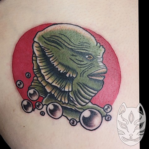 Gill man from The Creature from the Black Lagoon traditional tattoo on thigh by Gina Matuo of Copper Fox Tattoo in Kissimmee Florida