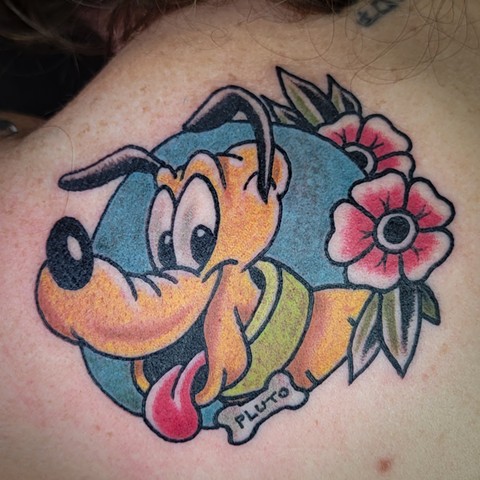 Disney Character Pluto in Traditional tattoo style on shoulder by Gina Matsuo of Copper Fox Tattoo in Kissimmee Florida best tattoo shop near me