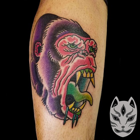 Custom gorilla tattoo in traditional style on lower leg