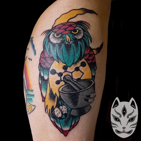 Traditional owl with mortar and pestle with chemical compound of caffeine on its belly on lower leg by Gina Matuo of Copper Fox Tattoo in Kissimmee Florida 