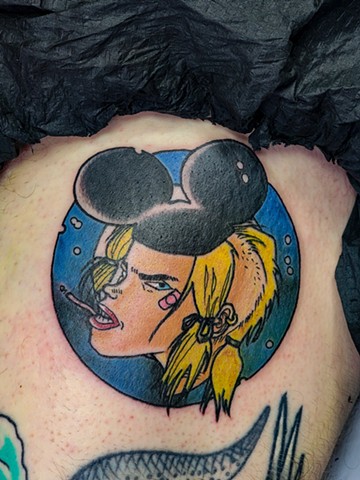Tank girl tattoo from tank girl comics in full color on thigh by Gina Matuo at copper Fox tattoo in Kissimmee Florida. Best tattoo shop in Kissimmee Orlando area