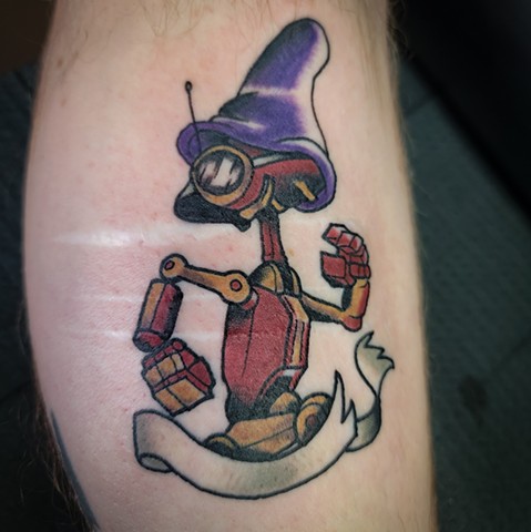 Star wars Pit Droid wearing Dopey Hat tattoo on lower leg by Gina Matsuo of Copper Fox Tattoo in Kissimmee Florida best tattoo shop near me disney tattoos