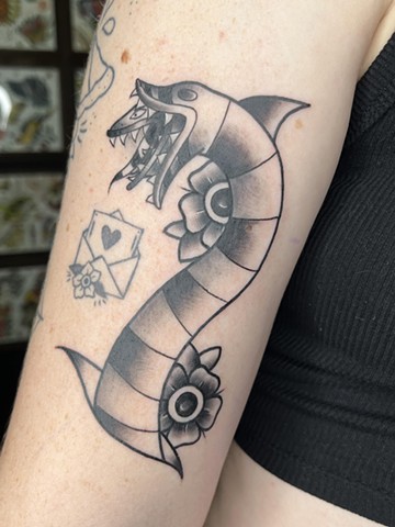 Black and Grey Traditional sandworm from the movie Beetlejuice by Kayla Arruda on inner bicep at Copper Fox Tattoo in Kissimmee Florida walk ins welcome