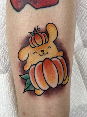 Pumpkin Pompompurin from Hello Kitty Sanrio by Kayla Arruda in full color calf tattoo at Copper Fox Tattoo in Kissimmee Florida oldest tattoo shop near me