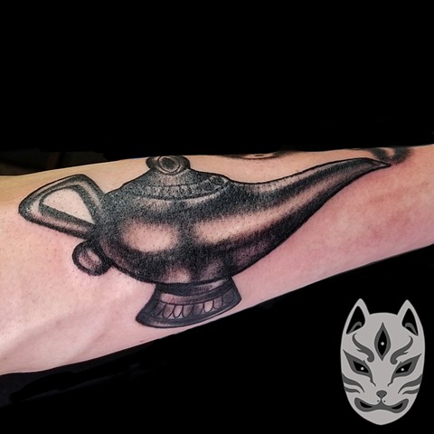 Black and grey Genie lamp from Disney Aladdin on forearm by Gina Matuo of Copper Fox in Kissimmee Florida