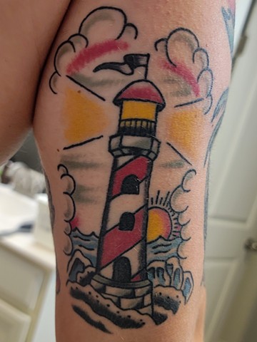 traditional light house tattoo on tricep by Gina Matsuo of Copper Fox Tattoo in Kissimmee Florida traditional tattoos near me