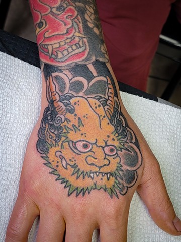 japanese style oni demon on hand tattoo by Gina Matuo of Copper Fox Tattoo in Kissimmee Florida best tattoo shop around oldest tattoo shop in town