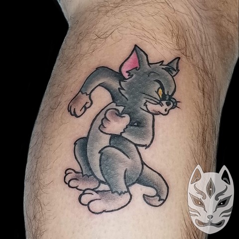 Tom from classic Hanna Barbara cartoon Tom and Jerry on lower leg