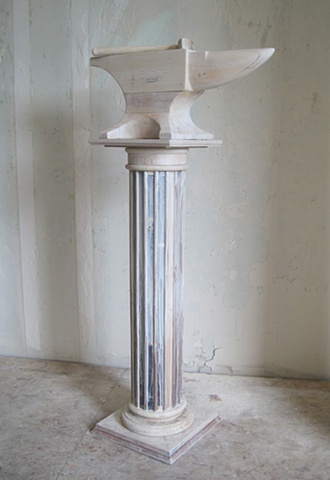 Sculpture of anvil and column made from reclaimed lumber