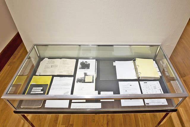 vitrines containing notebooks and studio archives