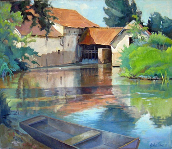 old mill in Cromary, France with small boat