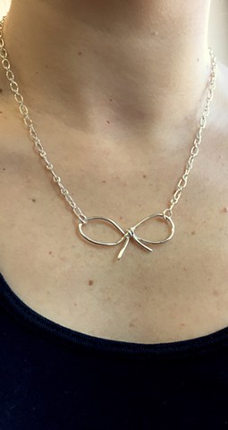 Bow necklace created out of sterling silver. 
