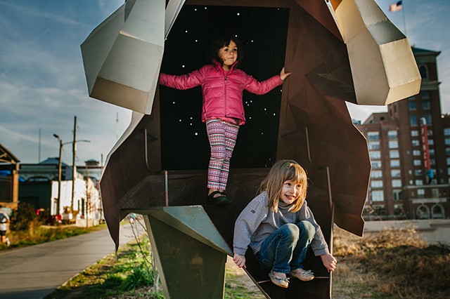 two children play in Mike Wsol's sculpture Laborer as part of Art on the Beltline in Atlanta, GA