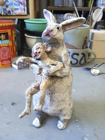 bunny eating boy ceramic sculpture by lisa schumaier