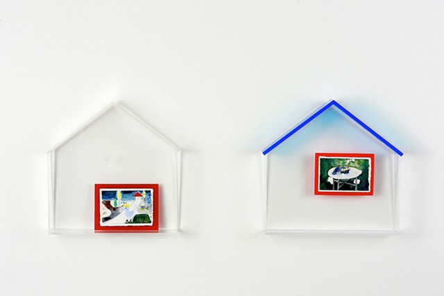 a picture with red frame and blue rooftop house 1