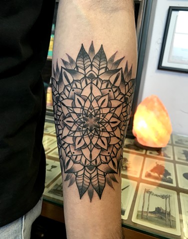 this is a tattoo of a mandala flower done in black and grey by Amanda Marie tattoo artist and owner of ace of wands tattoo in Los Angeles San Pedro California sacred private tattoo space and studio for magick and conceptual tattoos 