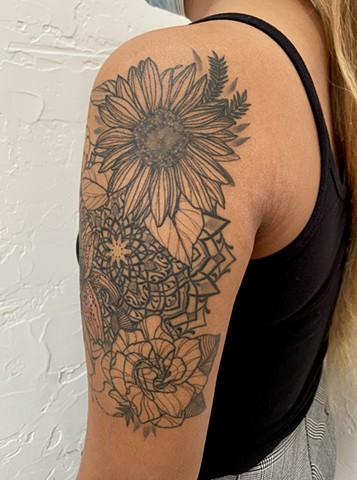 this is a floral tattoo that features a mandala and an ornamental style that is ornate and delicate done by Amanda Marie tattoo artist in Los Angeles California she is a tarot reader and artist and has a private studio ace of wands tattoo
