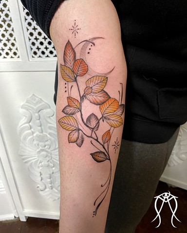 An ally for witnessing and honoring resilience and strength autumn beech tree leaves under the waning moon ornamental delicate nature based tattoo done by female tattoo artist and tarot reader Amanda Marie at her private tattoo and tarot studio in Scipio 