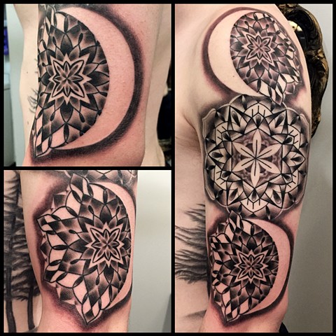 this is a geometric mandala tattoo representing the moon phases done in black and grey by amanda marie tattooer in los angeles california at evermore tattoo female tattoo artist 