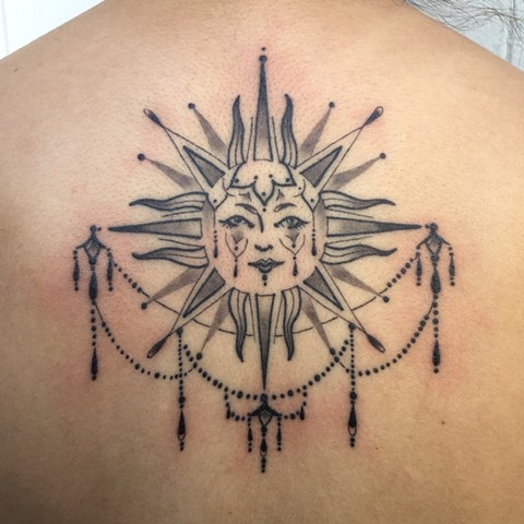 this is a black and grey tattoo of a sun mandala done by amanda marie tattooer in los angeles california 