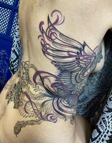 this is a tattoo of a mystical Phoenix rising from the ashes carrying magic and wisdom done in black and grey with a hint of color by Amanda Marie female tattoo artist and tarot reader in Los Angeles California at her private studio ace of wands tattoo 