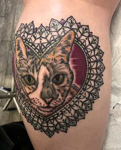 this is a tattoo of a kitty cat in a heart mandala geometric frame done by amanda marie tattooer at ace of wands tattoo private intimate tattoo studio in san pedro los angeles california 