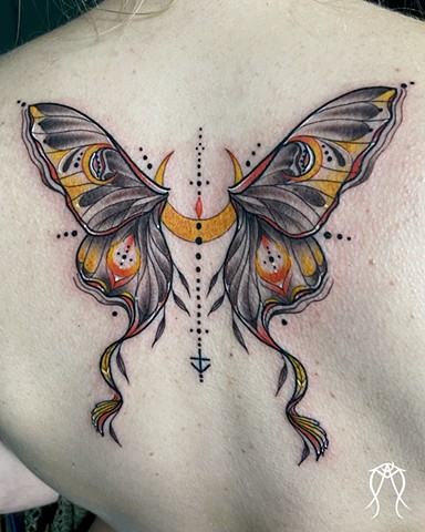 This is a magick sacred spiritual tattoo of a Luna moth done in black and grey with hints of color by tattoo artist and art witch Amanda Marie in her private tattoo studio in upstate New York just outside of Ithaca Amanda is a trauma informed lgbtq friend