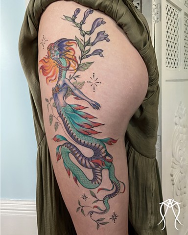 This is a mythological celestial siren dragon tattoo done in color by Amanda Marie female tattoo artist and tarot reader in her private studio in Ithaca New York Scipio center New York east coast tattoo it feature plant spirit art and magick 