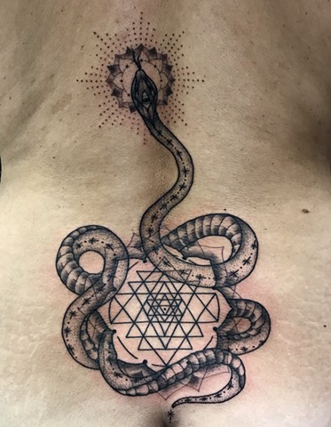 this is a tattoo of a kundalini snake done in a geometric style including a mandala and dotwork dot work done by Amanda Marie female tattooer at ace of wands tattoo in Los Angeles San Pedro California 