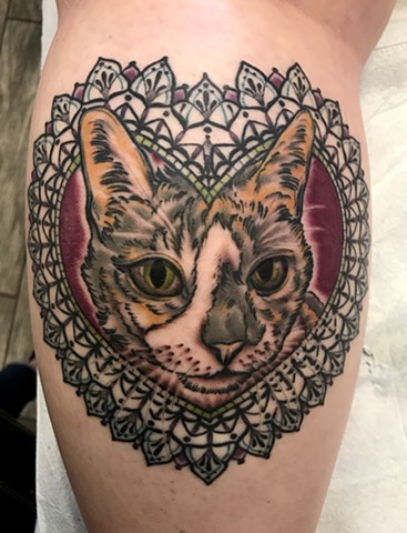 this is a tattoo of a kitty cat in a heart mandala geometric frame done by amanda marie tattooer at ace of wands tattoo private intimate tattoo studio in san pedro los angeles california 