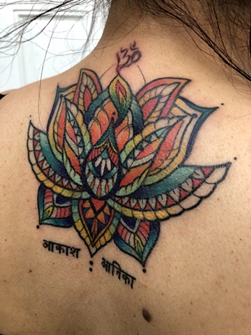 this is a mystical lotus tattoo done in a geometric style in color by amanda marie tattooer at ace of wands tattoo in san pedro los angeles palos verdes california 