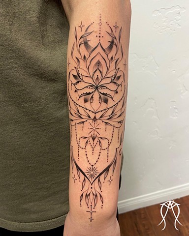 This is a delicate sacred moon magick ornamental tattoo done with a fine line in black and grey by female tattoo artist tarot reader and witch Amanda Marie at her tattoo and tarot studio in central New York Scipio center Cayuga Ithaca nature floral orname